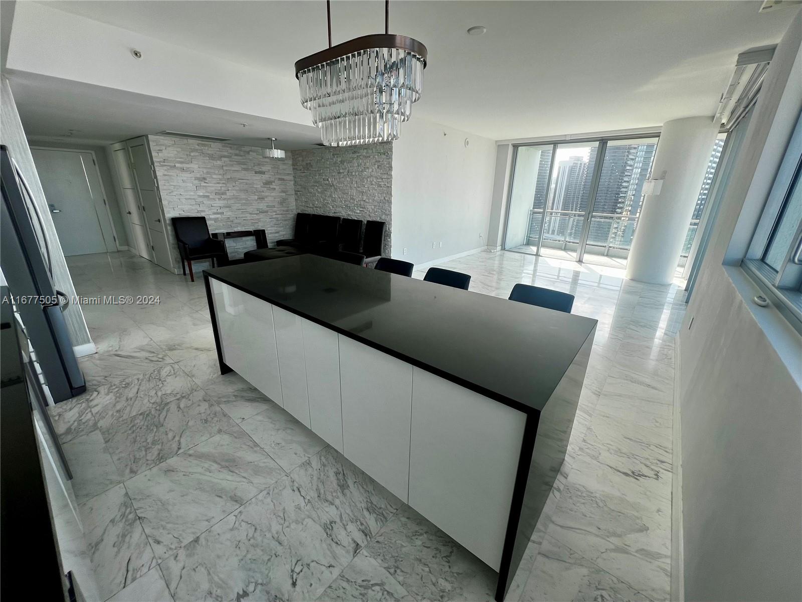 92 Southwest 3rd Street, Unit 3605 Miami, FL 33130 - Photo 12 of 24 a living room with furniture and a chandelier