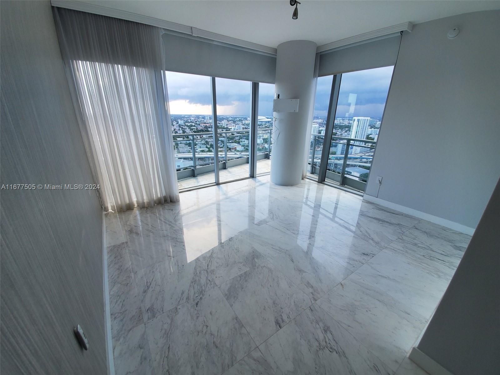 92 Southwest 3rd Street, Unit 3605 Miami, FL 33130 - Photo 16 of 24 wooden floor in an empty room with a window