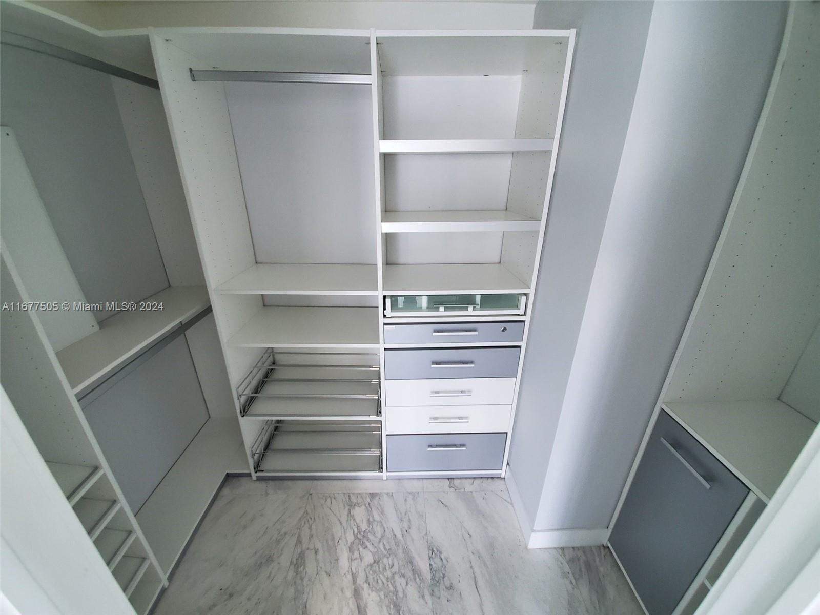 92 Southwest 3rd Street, Unit 3605 Miami, FL 33130 - Photo 18 of 24 a view of walk in closet with empty racks