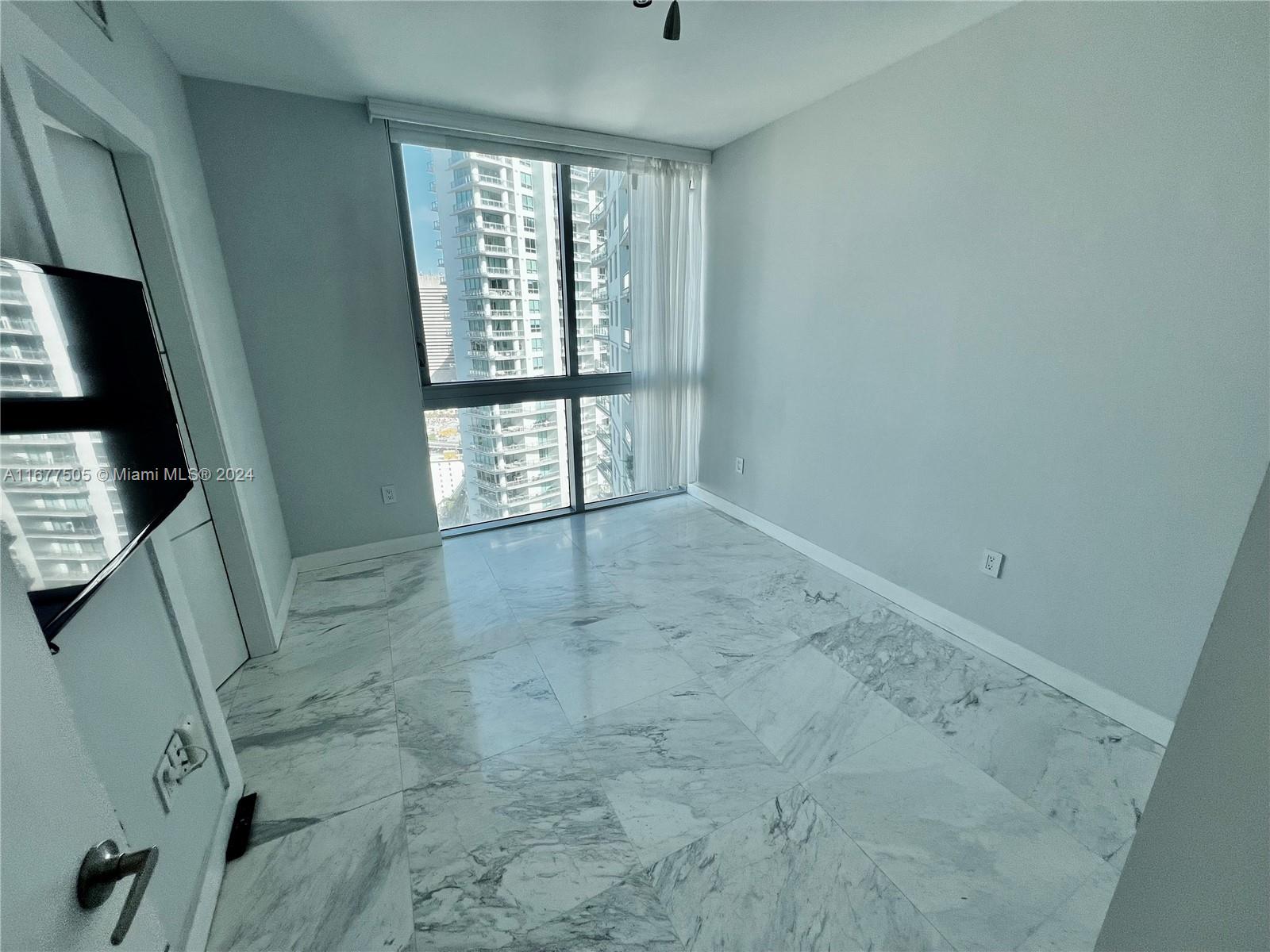 92 Southwest 3rd Street, Unit 3605 Miami, FL 33130 - Photo 20 of 24 a view of an empty room with a window