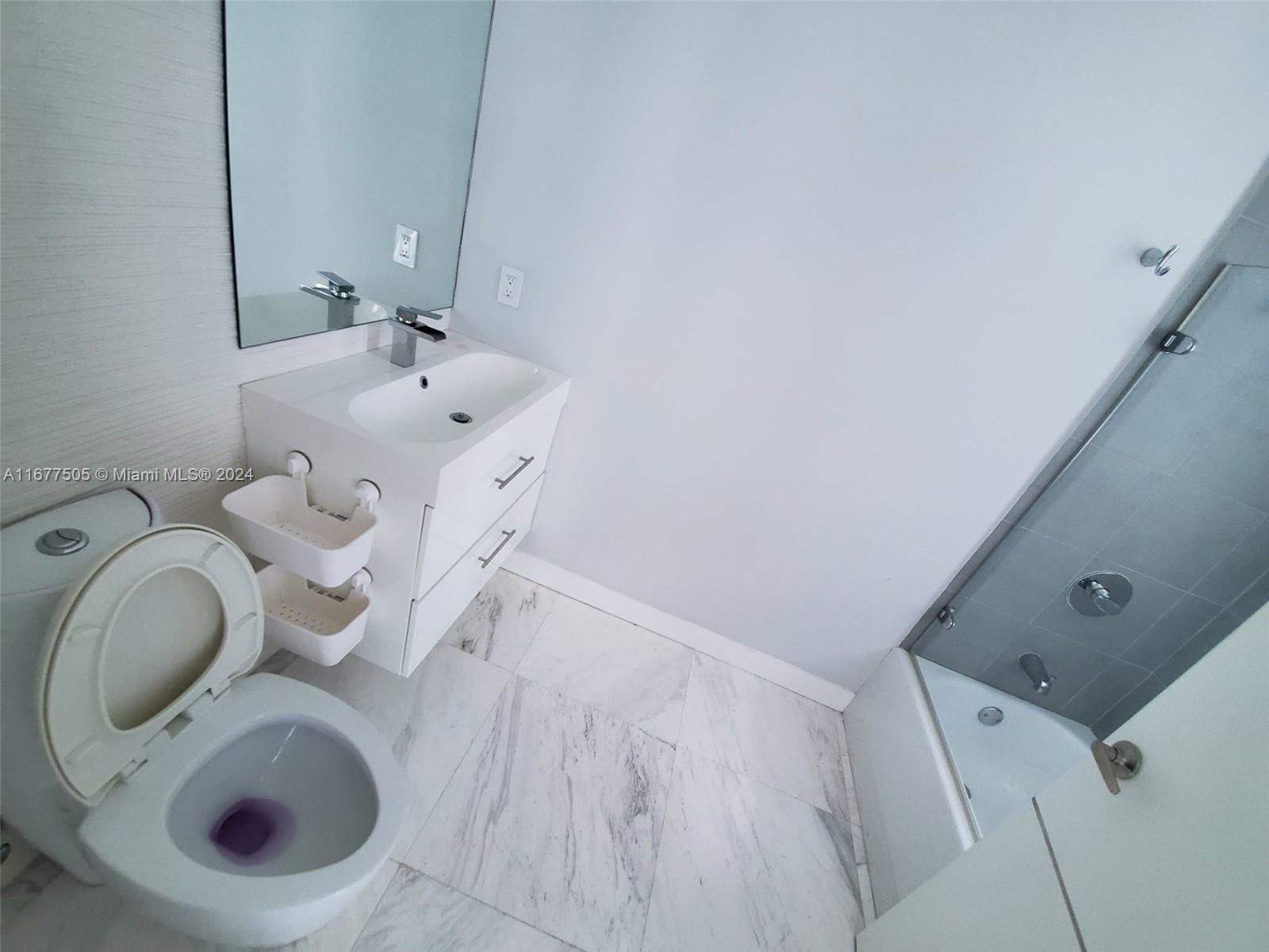 92 Southwest 3rd Street, Unit 3605 Miami, FL 33130 - Photo 21 of 24 a bathroom with a sink and a toilet