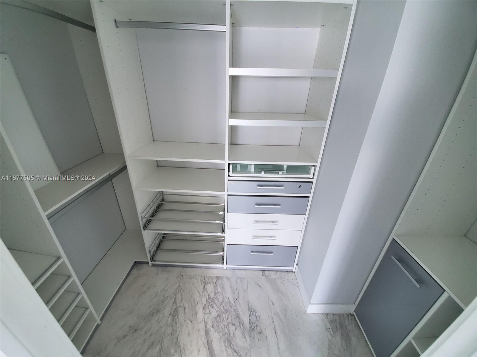 92 Southwest 3rd Street, Unit 3605 Miami, FL 33130 - Photo 22 of 24 a view of walk in closet with empty racks