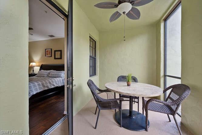 8945 Malibu Street, Unit 204 Naples, FL 34113 - Photo 13 of 21 a view of a dining room with furniture and a chandelier