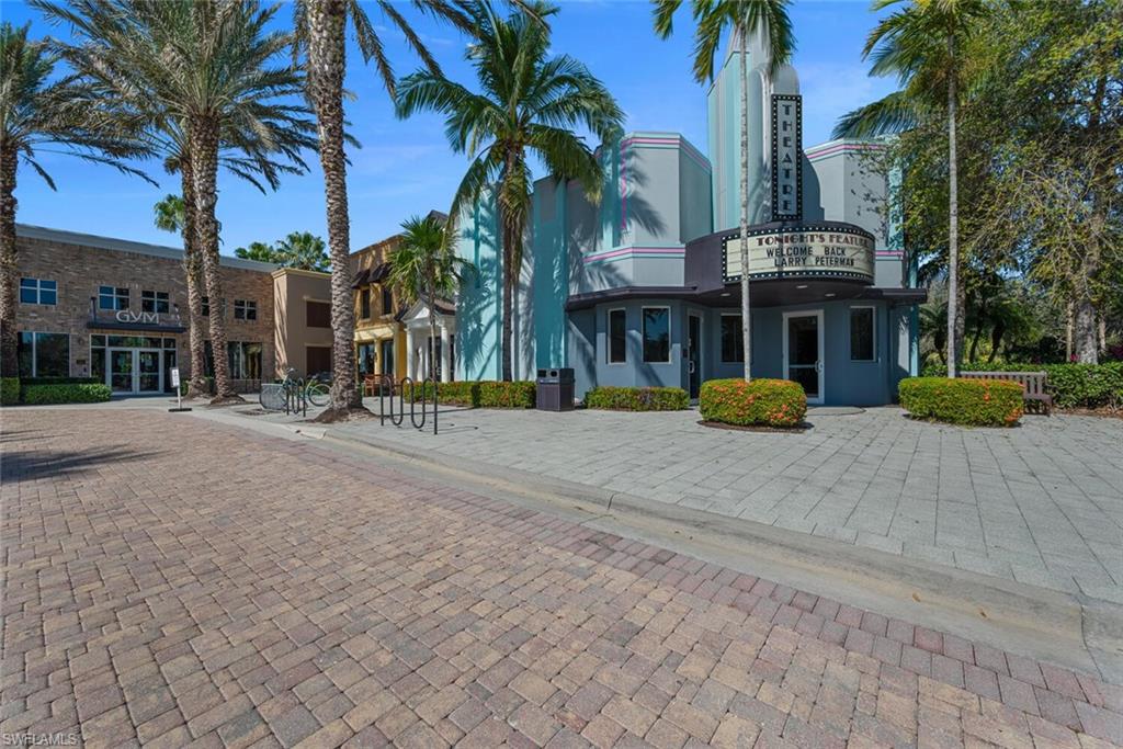 8945 Malibu Street, Unit 204 Naples, FL 34113 - Photo 20 of 21 a view of a building with a yard and palm trees
