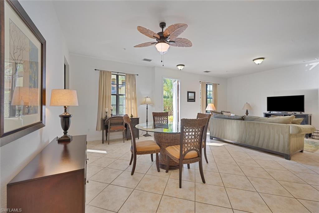 8945 Malibu Street, Unit 204 Naples, FL 34113 - Photo 4 of 21 a living room with furniture and a flat screen tv