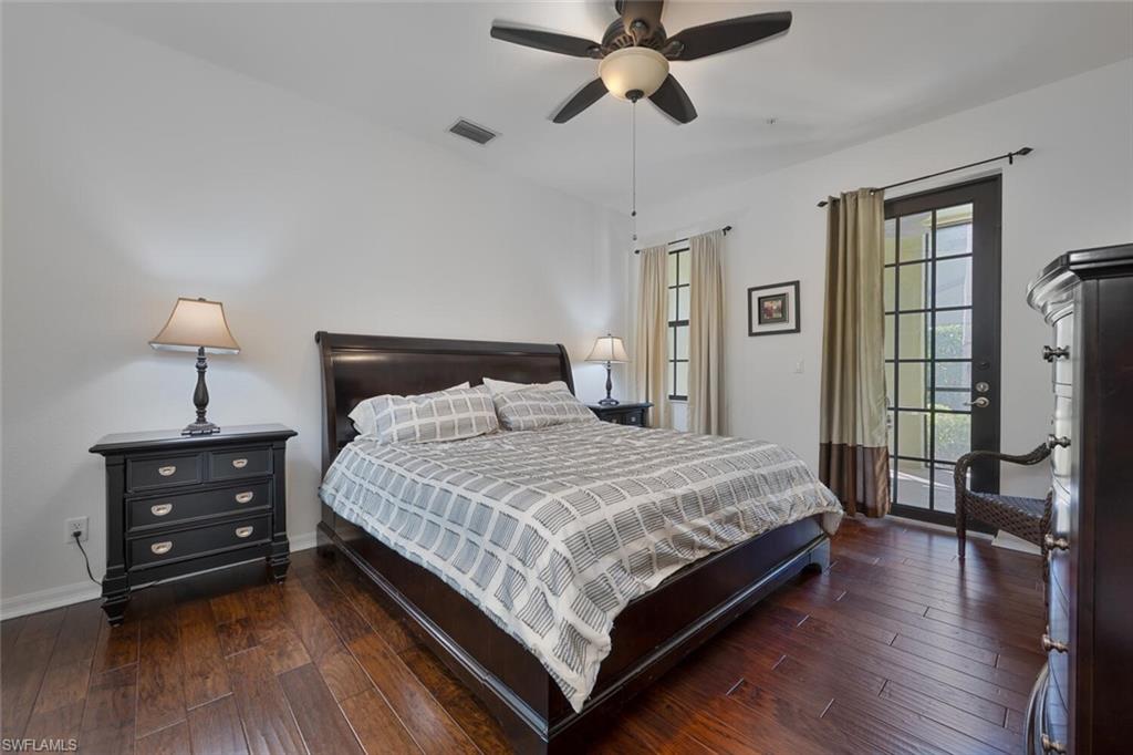8945 Malibu Street, Unit 204 Naples, FL 34113 - Photo 10 of 21 a bedroom with a bed and wooden floor