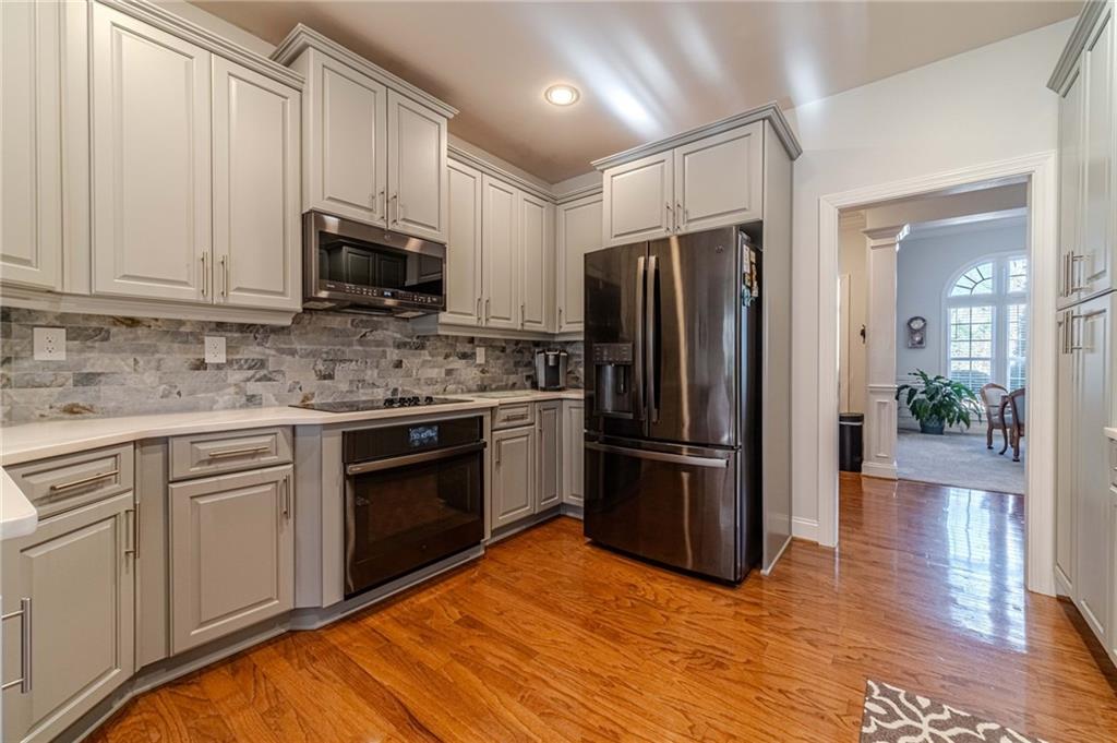 1245 White Columns Drive Monroe, GA 30656 - Photo 11 of 52 a kitchen with granite countertop a refrigerator stove and microwave