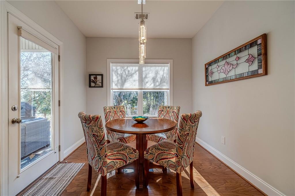 1245 White Columns Drive Monroe, GA 30656 - Photo 15 of 52 a dining room with furniture a chandelier and wooden floor