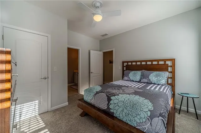 a spacious bedroom with a bed and a chandelier