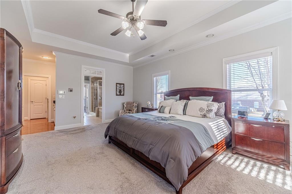 1245 White Columns Drive Monroe, GA 30656 - Photo 27 of 52 a spacious bedroom with a bed and a chandelier