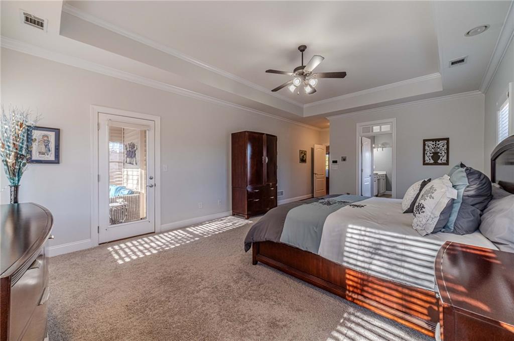 1245 White Columns Drive Monroe, GA 30656 - Photo 28 of 52 a bed room with a bed and a chandelier