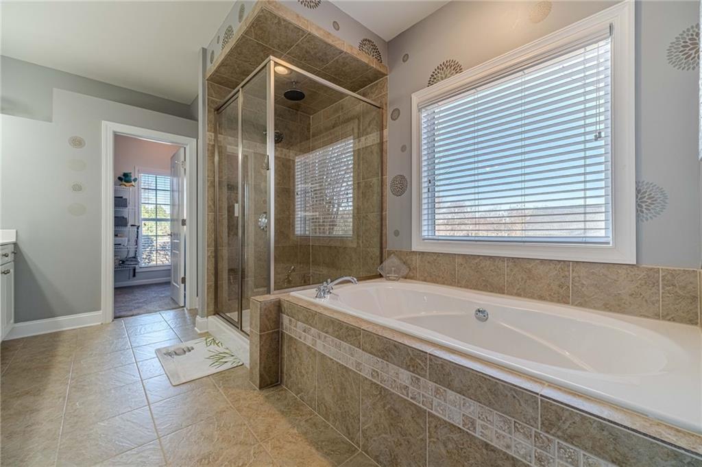 1245 White Columns Drive Monroe, GA 30656 - Photo 30 of 52 a spacious bathroom with a tub shower and sink