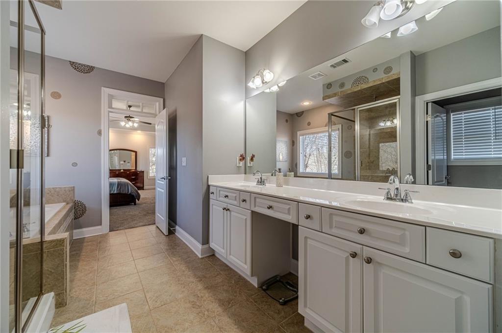 1245 White Columns Drive Monroe, GA 30656 - Photo 31 of 52 a spacious en suite bathroom with a double vanity sink and a mirror