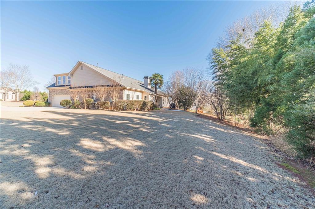 1245 White Columns Drive Monroe, GA 30656 - Photo 45 of 52 a front view of a house with a yard and garage