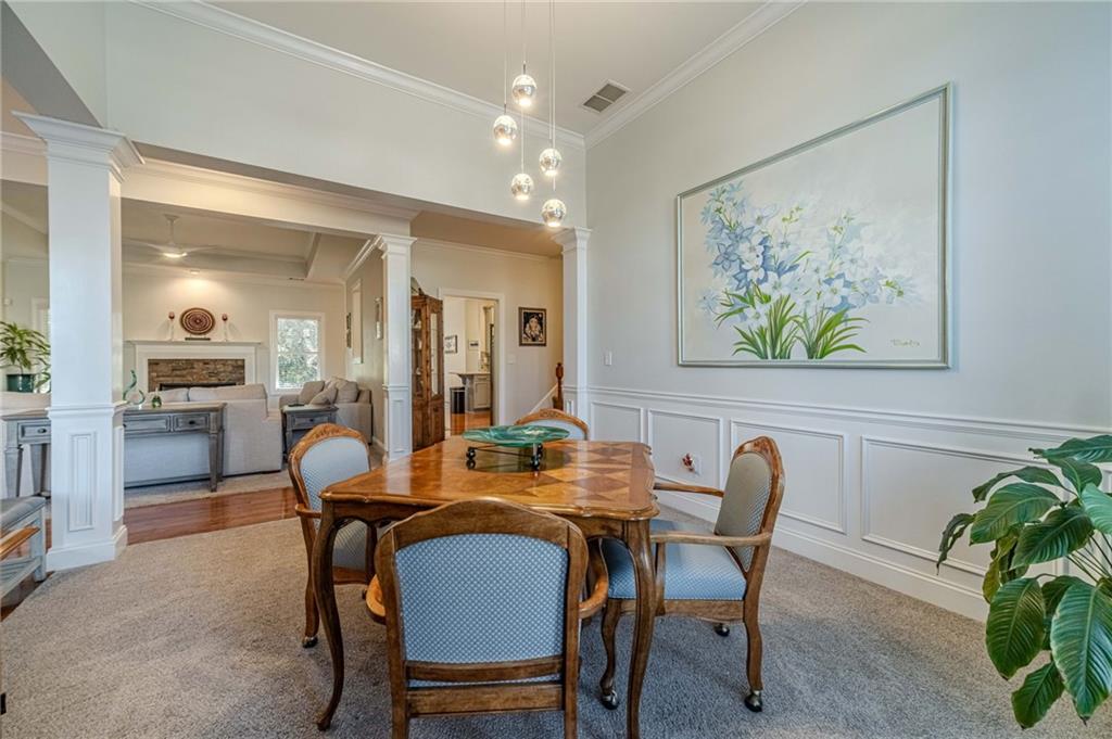 1245 White Columns Drive Monroe, GA 30656 - Photo 6 of 52 a view of a dining room with furniture and a potted plant