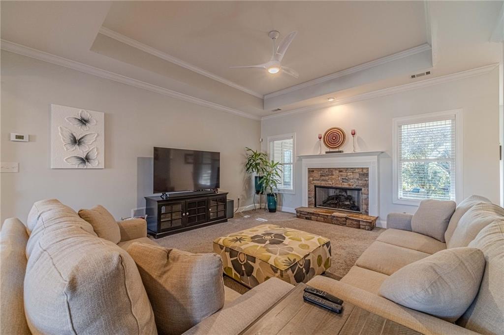1245 White Columns Drive Monroe, GA 30656 - Photo 9 of 52 a living room with furniture a flat screen tv and a fireplace
