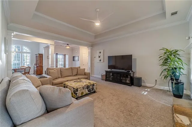 a kitchen with stainless steel appliances granite countertop a stove top oven a sink dishwasher a dining table and chairs with wooden floor