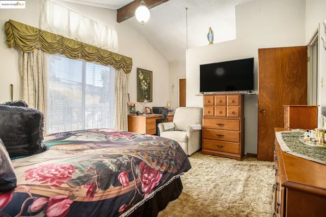 a bedroom with a bed and flat screen tv