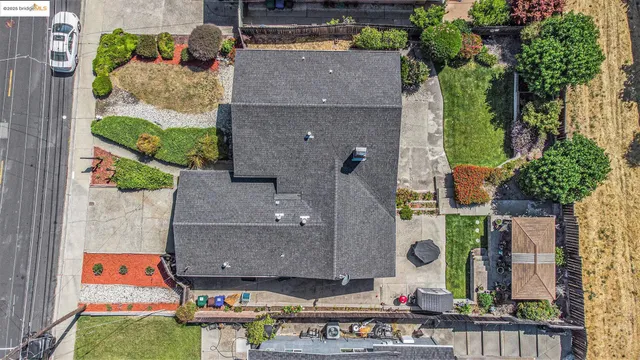 an aerial view of residential houses with city view
