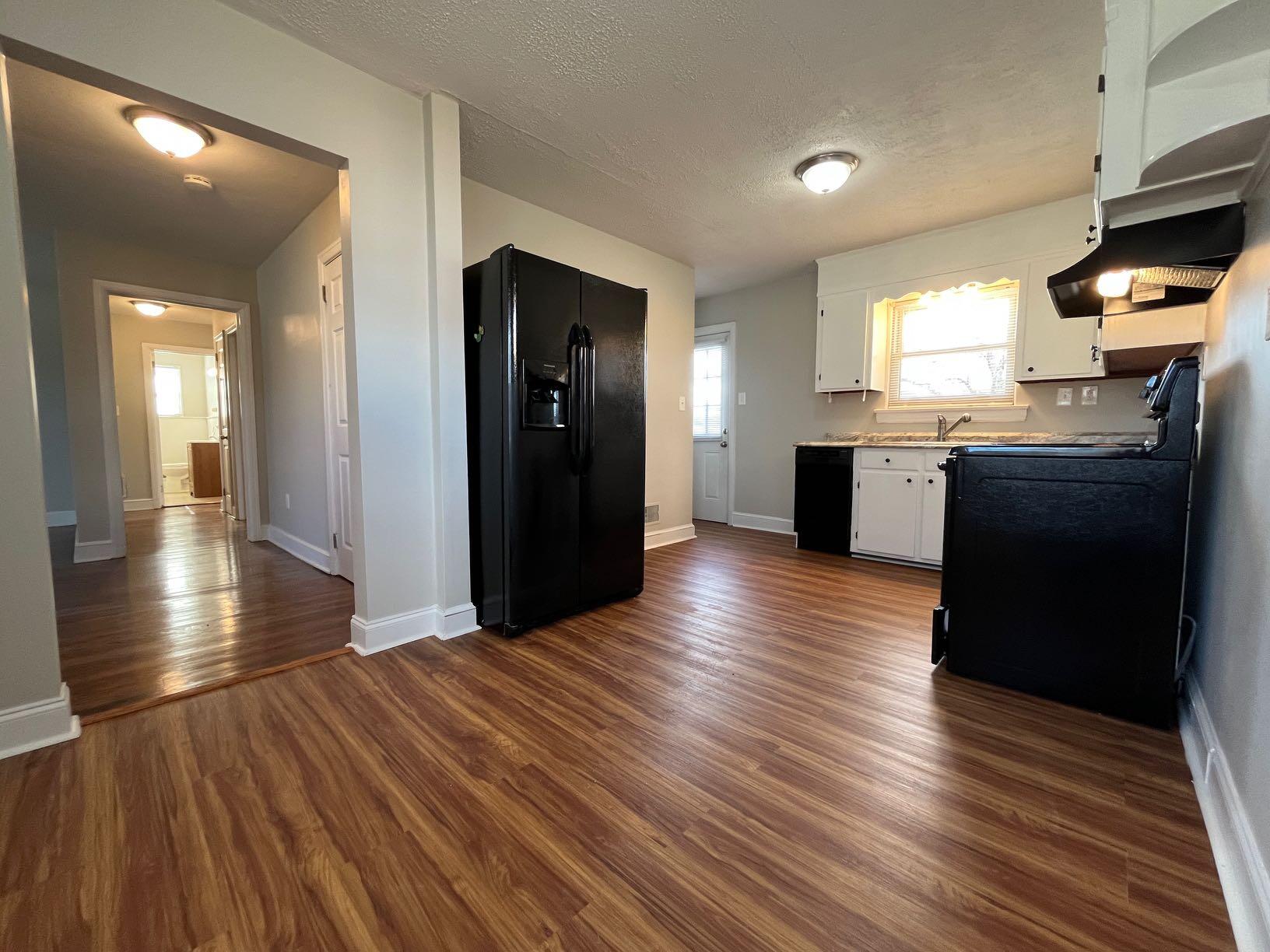 1939 Barrington Drive Northwest Roanoke, VA 24017 - Photo 10 of 14 a view of a kitchen with wooden floor and cabinets