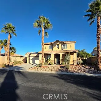 a front view of a house with plants