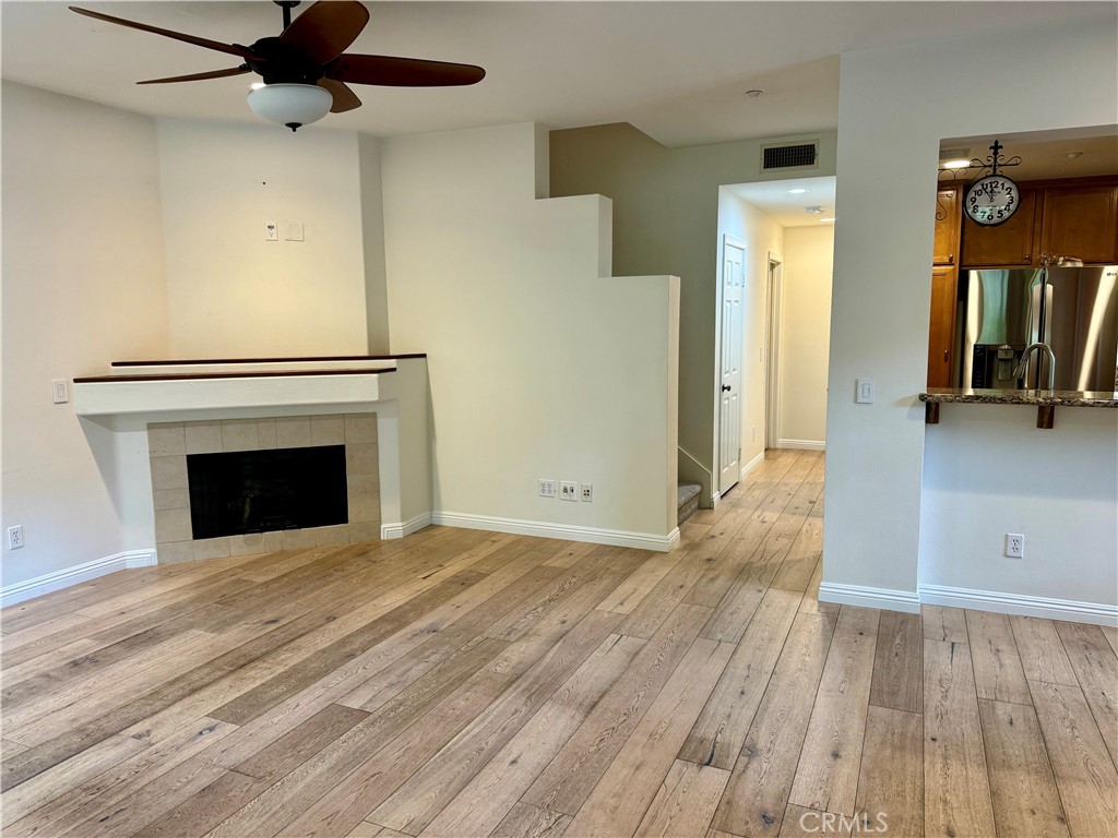 238 Coral Rose Irvine, CA 92603 - Photo 3 of 19 a view of empty room with wooden floor and fan