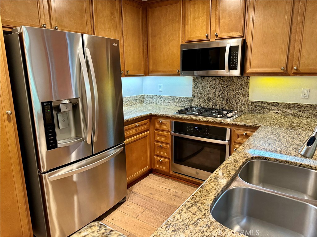 238 Coral Rose Irvine, CA 92603 - Photo 7 of 19 a kitchen with a refrigerator sink and microwave