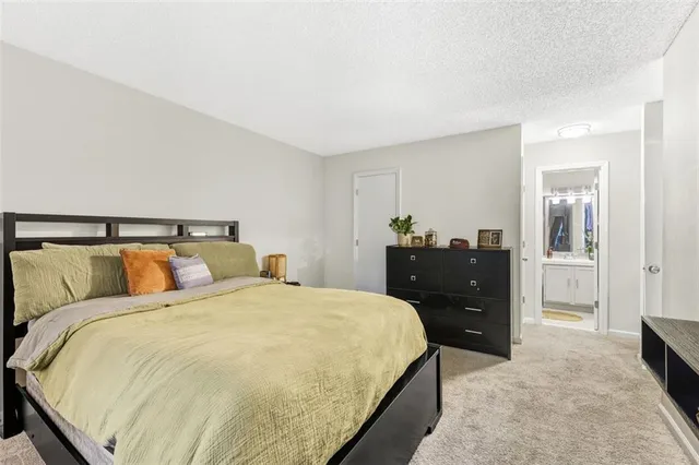 a bed sitting in a bedroom and a mirror