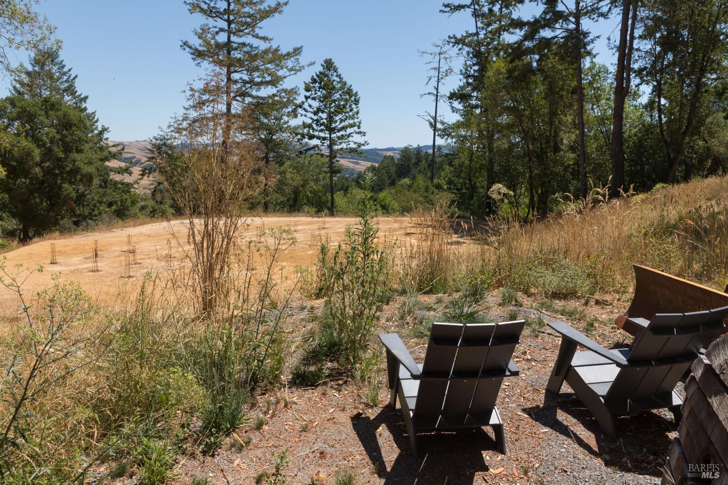 70 Fox Drive Point Reyes Station, CA 94956 - Photo 16 of 34 a view of a lake with a table and chairs