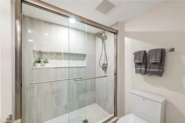 a bathroom with a shower and a sink