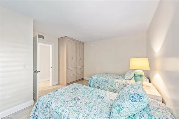 a bedroom with a bed and a lamp