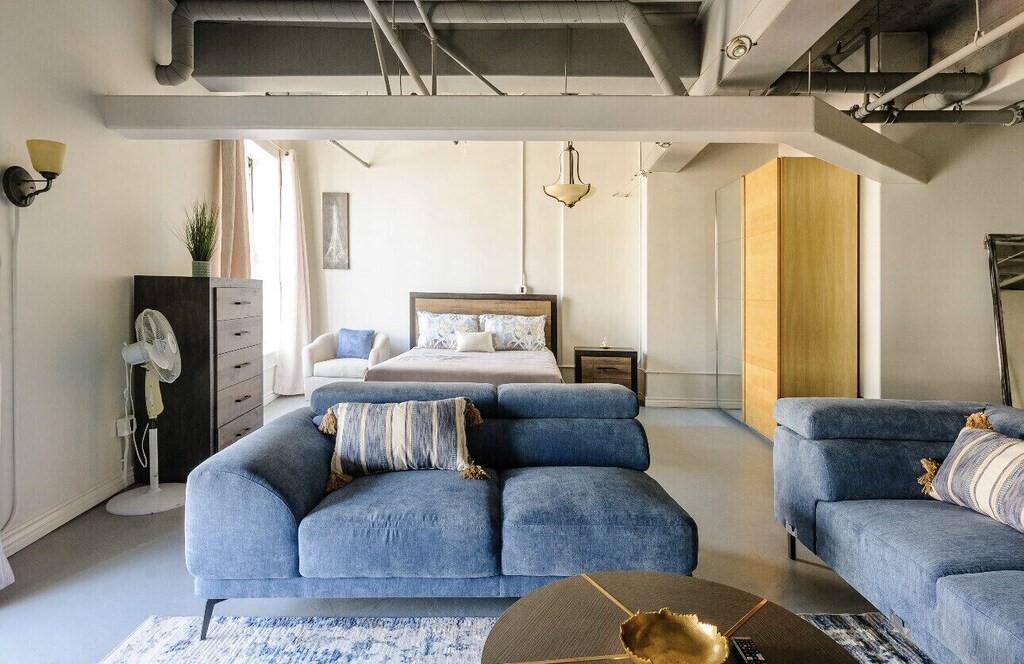 312 West 5th Street, Unit 1003 Los Angeles, CA 90013 - Photo 18 of 20 a living room with furniture and a window