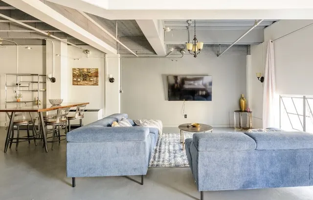 a living room with furniture and a flat screen tv