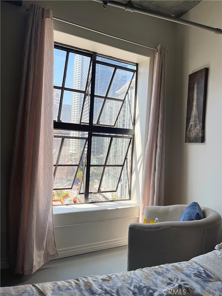 312 West 5th Street, Unit 1003 Los Angeles, CA 90013 - Photo 10 of 20 a living room with furniture and a window