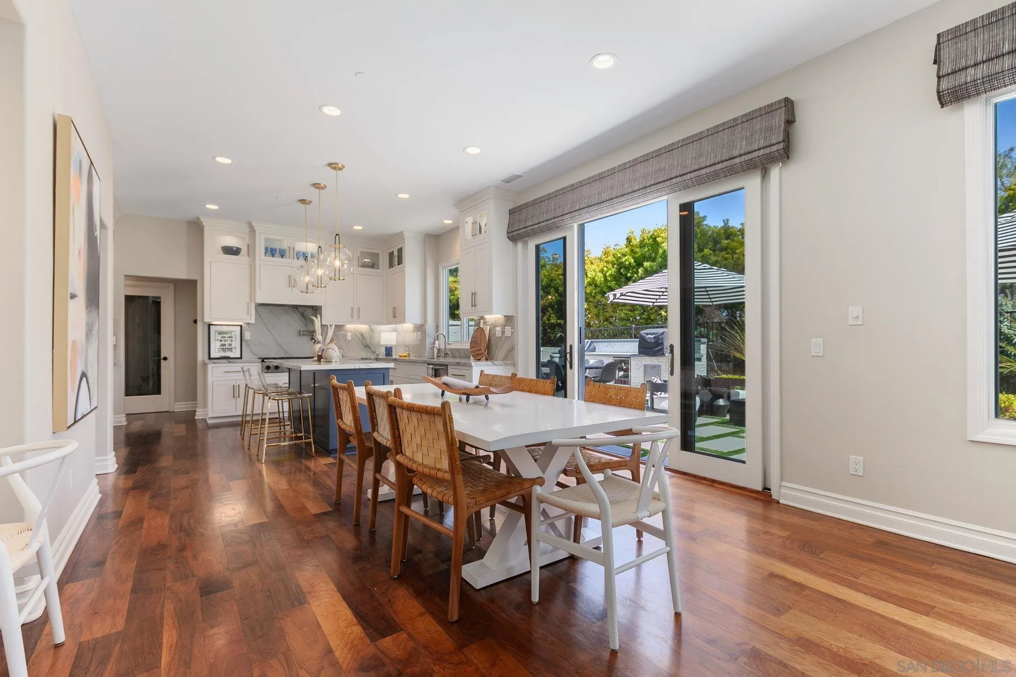 329 Chopin Way Cardiff, CA 92007 - Photo 13 of 47 a view of a dining room and kitchen with a wooden floor