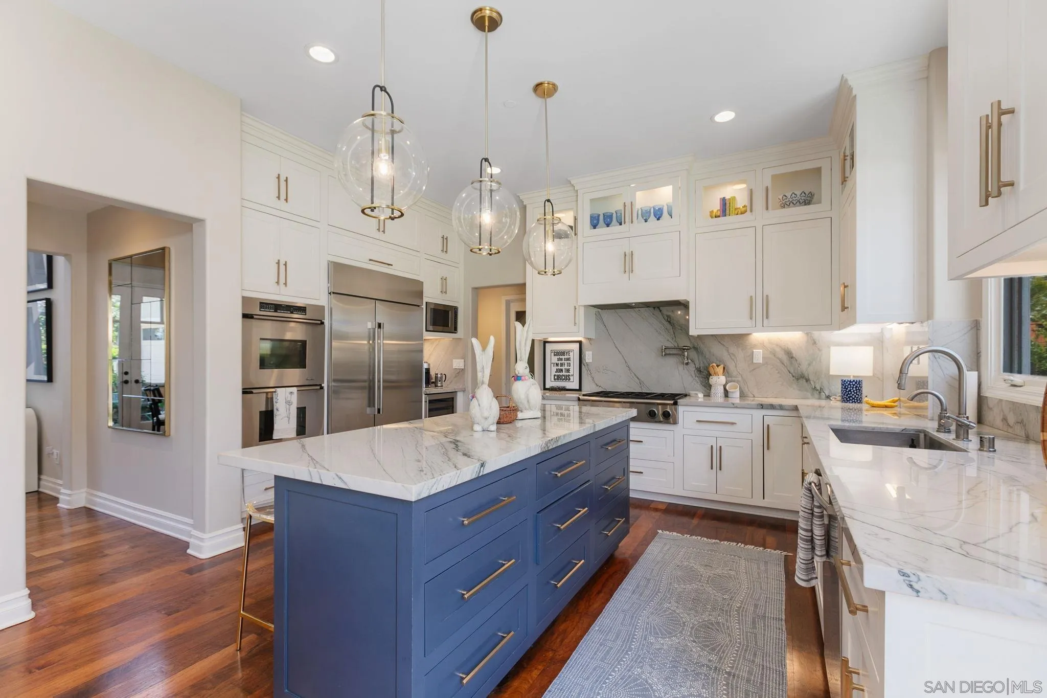 329 Chopin Way Cardiff, CA 92007 - Photo 14 of 47 a large kitchen with stainless steel appliances granite countertop a lot of counter space and wooden floors