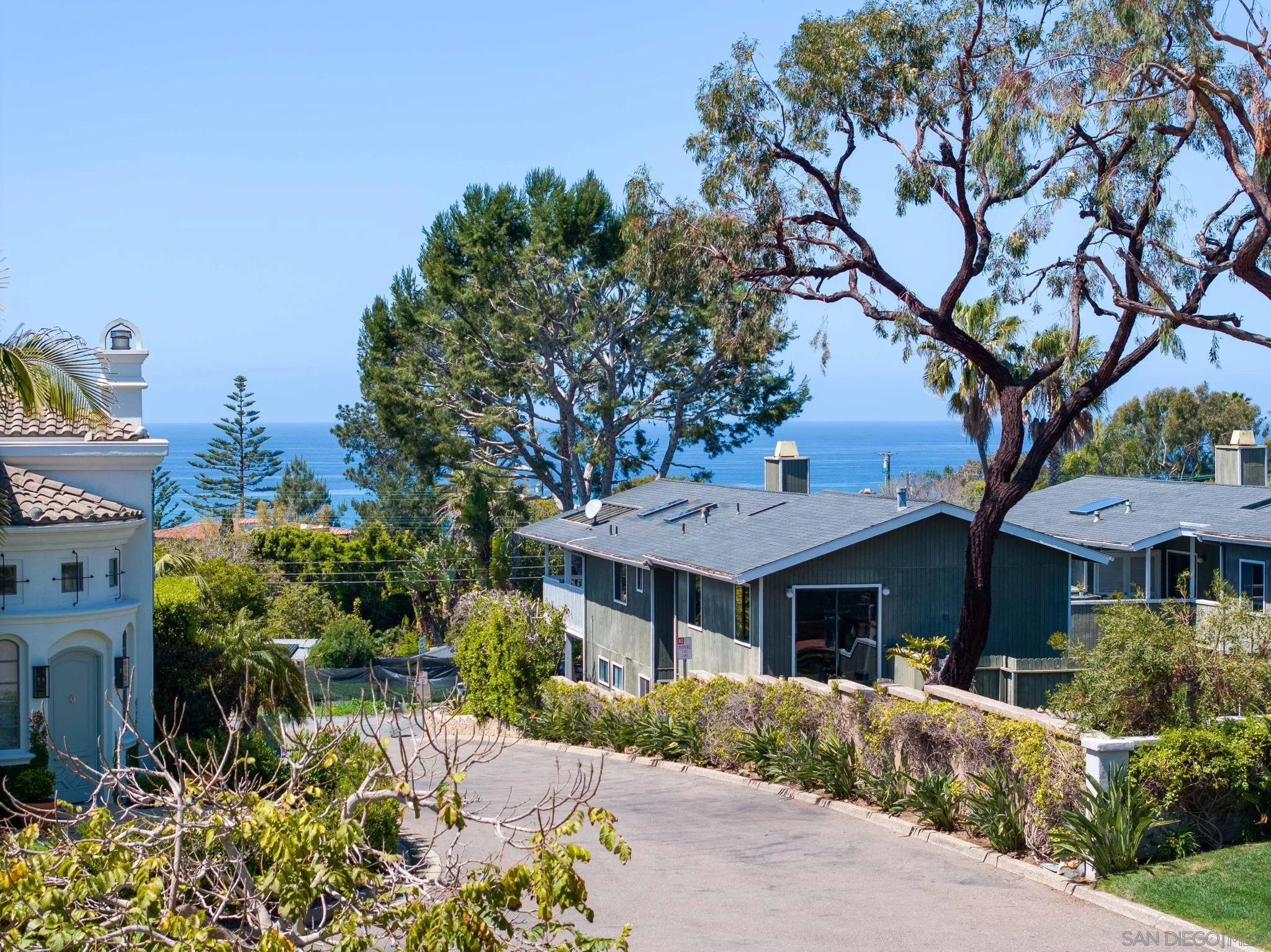 329 Chopin Way Cardiff, CA 92007 - Photo 42 of 47 a front view of a house with a yard and trees