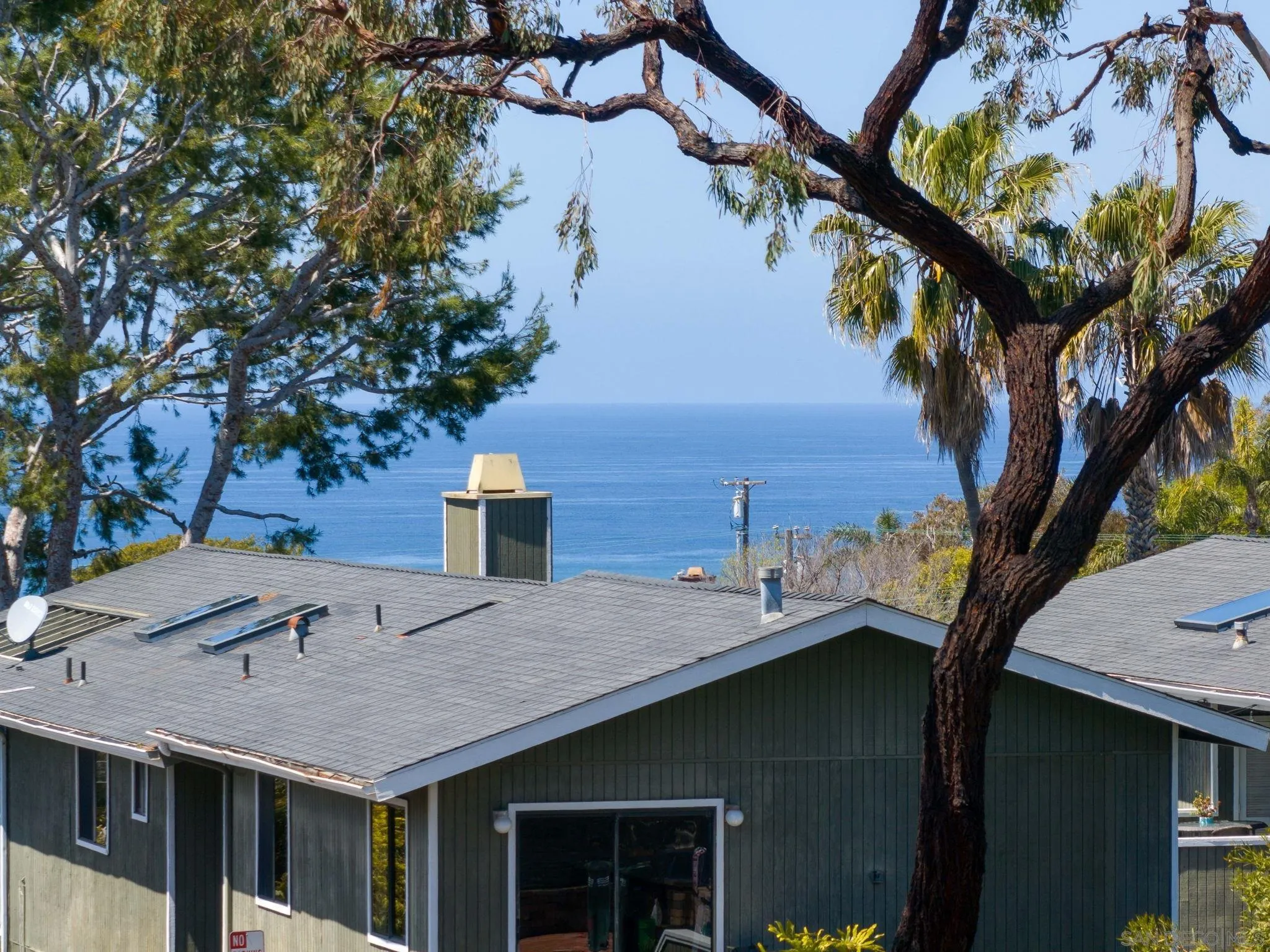 329 Chopin Way Cardiff, CA 92007 - Photo 43 of 47 a roof deck with table and chairs under an umbrella