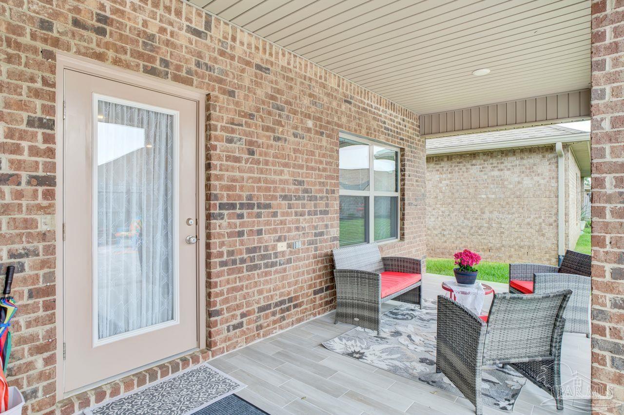 5364 Red Shoulder Road Pace, FL 32571 - Photo 45 of 46 a living room with furniture and a potted plant