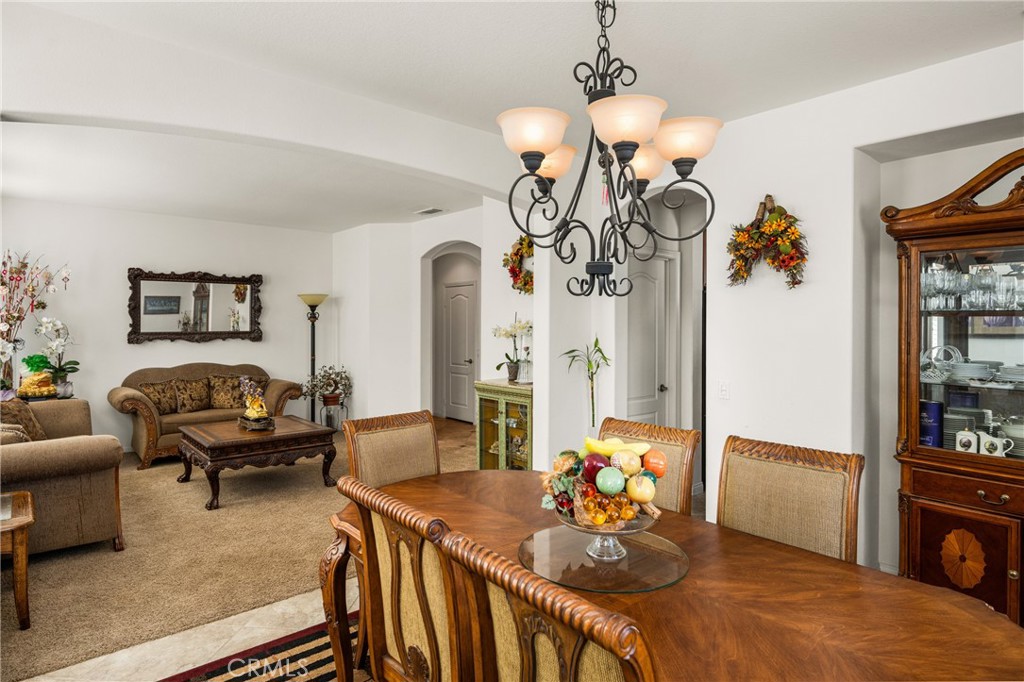 12652 Twin Peak Court Riverside, CA 92503 - Photo 17 of 55 a living room with furniture a chandelier and a wooden floor
