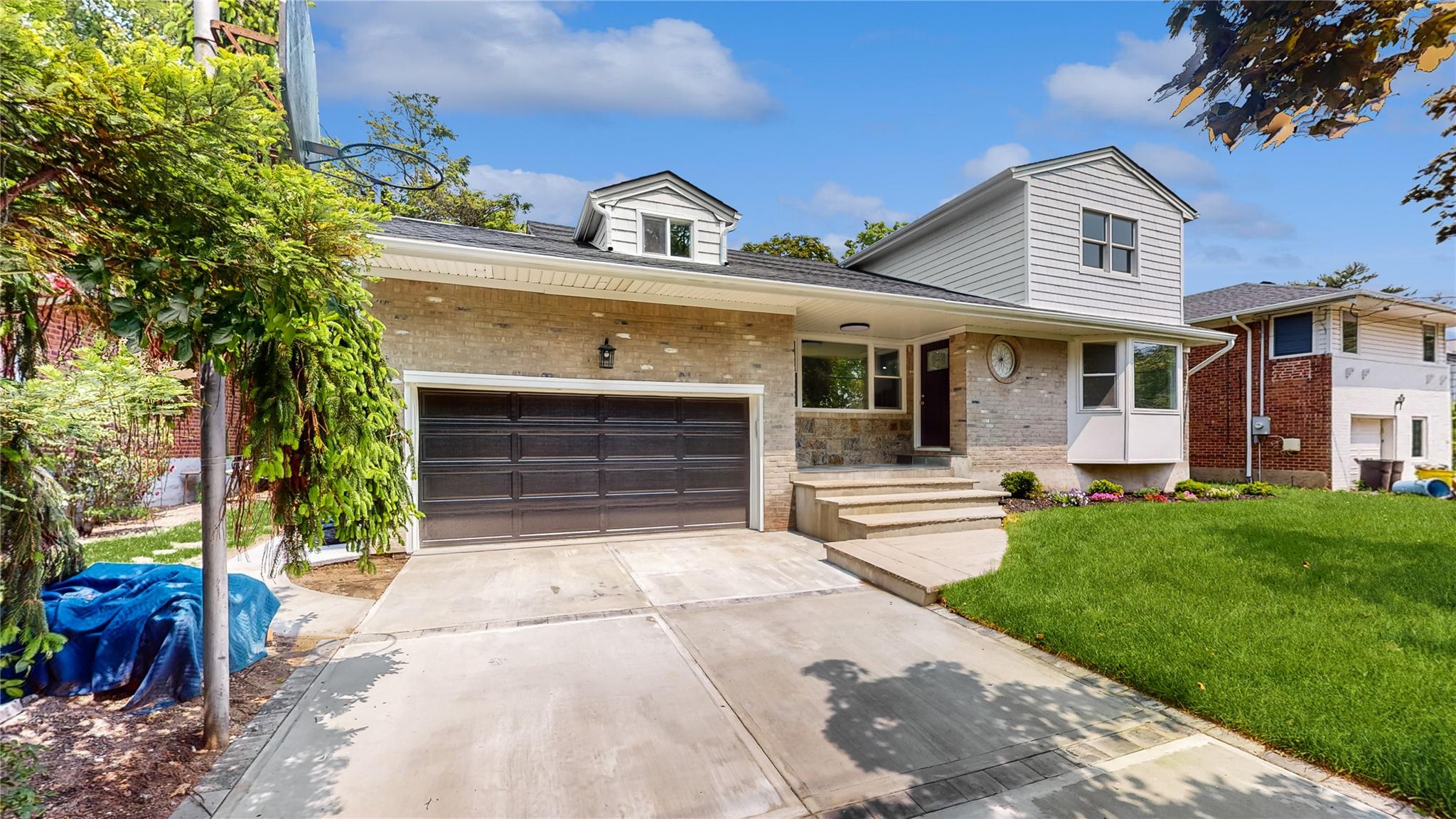 706 Longacre Avenue Woodmere, NY 11598 - Photo 1 of 43 a front view of a house with a garden