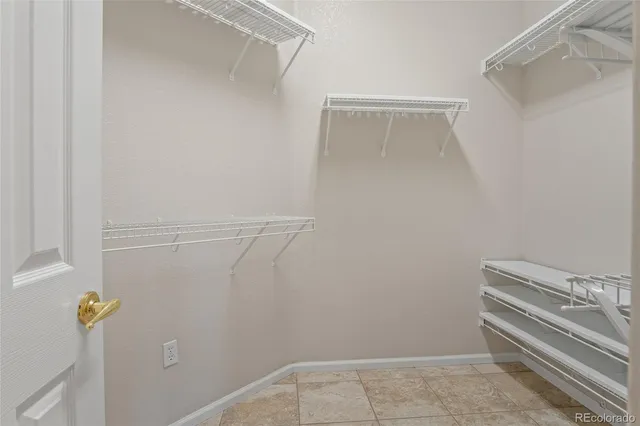 a view of storage and utility room with racks on the wall