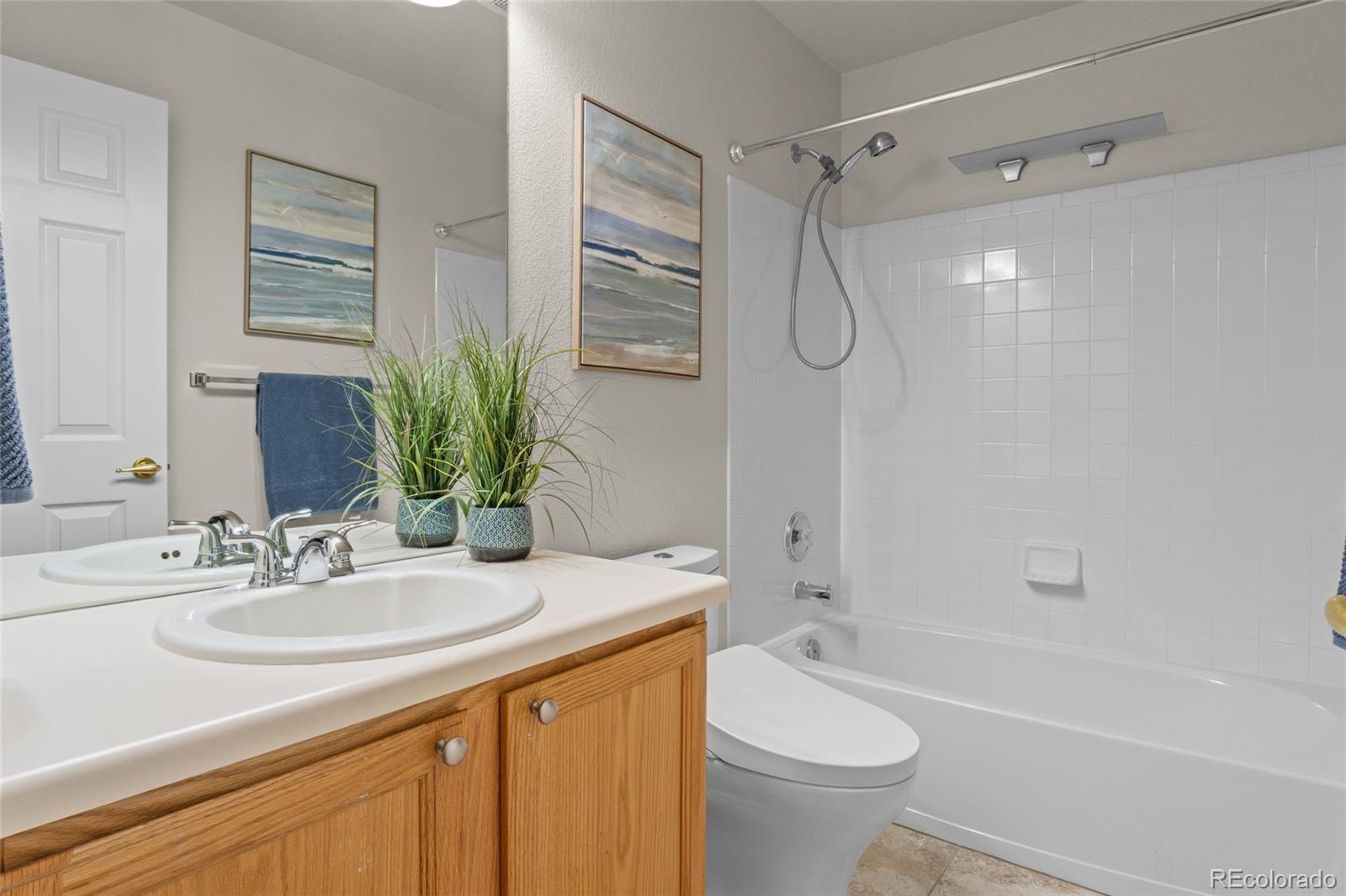 20800 Omaha Avenue Parker, CO 80138 - Photo 22 of 38 a bathroom with a granite countertop sink a toilet and shower