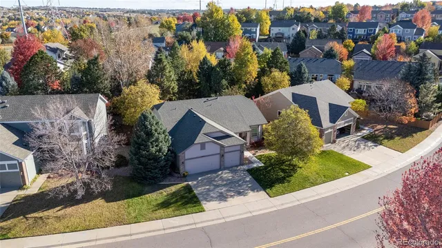 an aerial view of multiple houses with a street