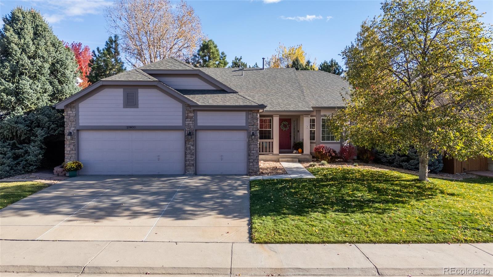 20800 Omaha Avenue Parker, CO 80138 - Photo 38 of 38 a front view of a house with a yard and garage