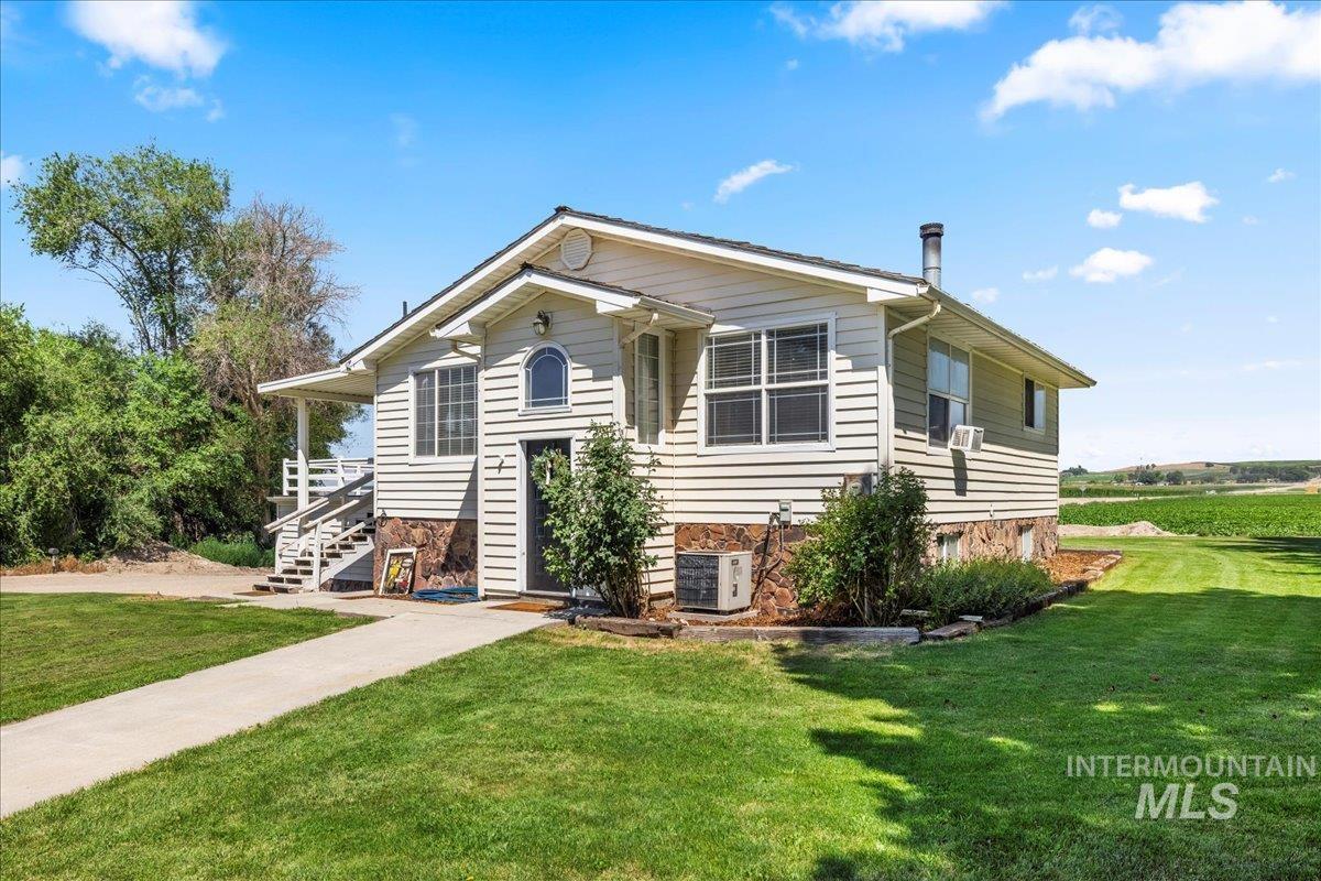 24497 Hoskins Road Wilder, ID 83676 - Photo 1 of 1 View of front of home with a front lawn and stone siding