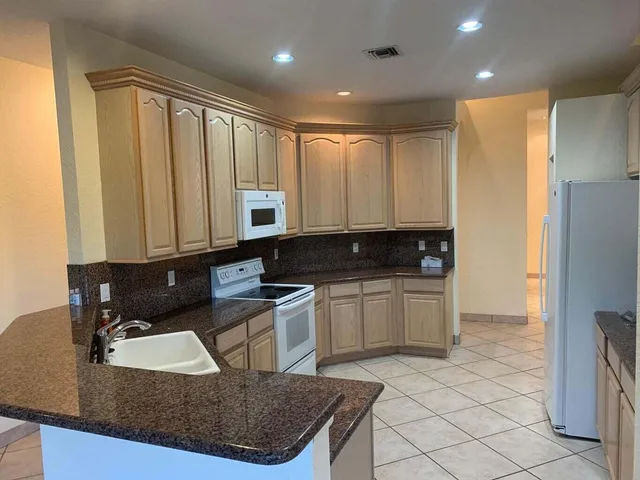a kitchen with a sink cabinets and appliances