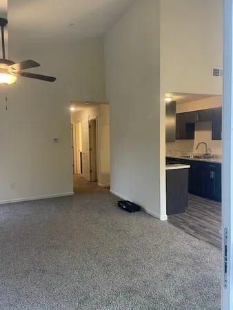 an empty room with a kitchen and a sink