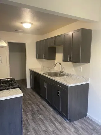 a spacious bathroom with a granite countertop sink and a mirror