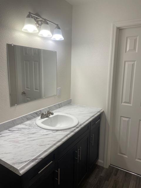 540 South Argyle Avenue, Unit 101 Fresno, CA 93727 - Photo 7 of 11 a bathroom with a granite countertop sink and a mirror